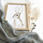 Cadre avec affiche aquarelle d'un lapin avec des grandes oreilles pour décorer la chambre d'un bébé.
